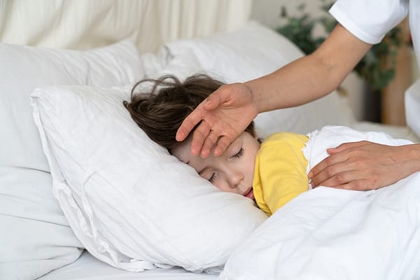 child sick in bed with fever